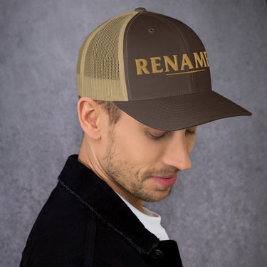 Male model wearing Renamed Trucker Cap in Brown/Khaki, front embroidery close-up (right front position)